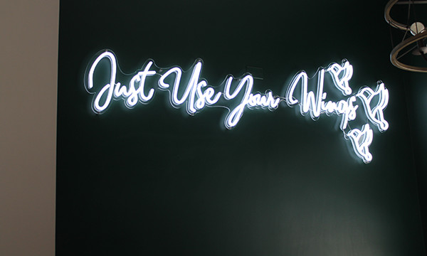 "Just Use Your Wings" spelled out in lights