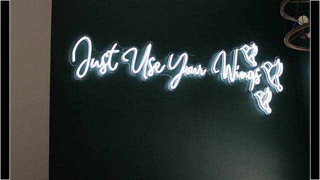 "Just Use Your Wings" spelled out in lights