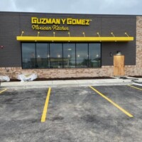 Exterior lighting and signage at Guzman y Gomez