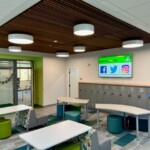 A photo of a school common area illuminated by decorative circular lights