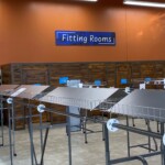 A photo of retail lighting over a the goodwill fitting rooms